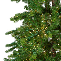 Green artificial pine tree branches with warm white string lights woven through the needles, shown against a plain white background.