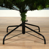 Black metal tree stand with a Christmas tree on a wooden floor.
