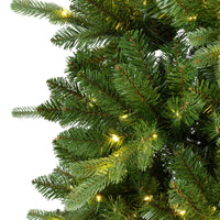 Close-up of green artificial needles and warm white LED lights on the Everlands Killington Christmas tree